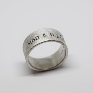 bred silverring med text på vit bakgrund